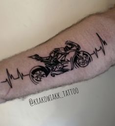 a man with a motorcycle tattoo on his arm