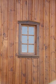 a window on the side of a wooden building