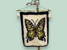 a wall hanging with a yellow butterfly on it