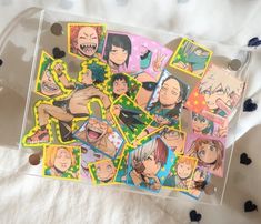 an assortment of anime stickers on a bed