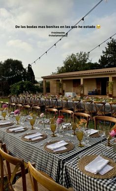 an outdoor dining area with tables and chairs set up for a formal dinner or party