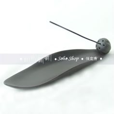 a black object with a ladybug on it's back and the words souffle shop written in chinese