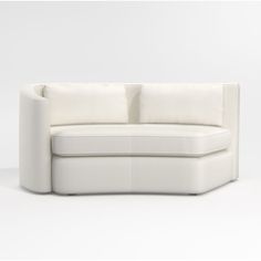 a white couch sitting on top of a white floor