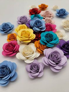 multicolored paper flowers arranged on a white surface