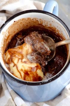 a blue pot filled with food and a spoon