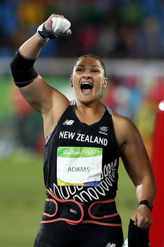 a female athlete celebrating her win in the women's 800m hurdles at an olympic event