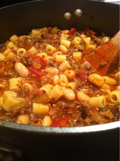 a pot filled with macaroni and cheese on top of a stove