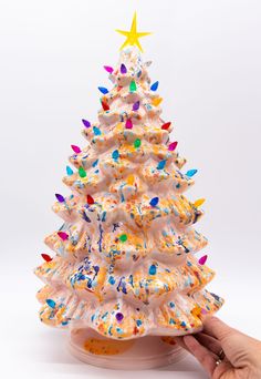 a white christmas tree with sprinkles on it