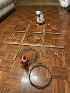 a dog is sitting on the floor next to a cross made out of sticks and candy canes