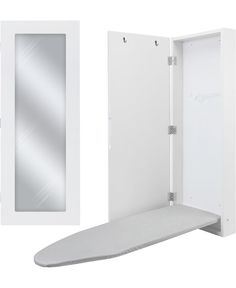 a white wall mounted mirror next to an ironing board