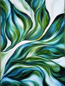 an abstract painting with green and blue swirls on white paper, framed in gold frame