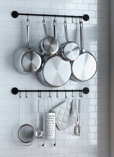 pots and pans are hanging on the wall