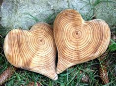 two heart shaped wood pieces laying on the ground