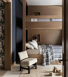 a bedroom with bunk beds and a chair