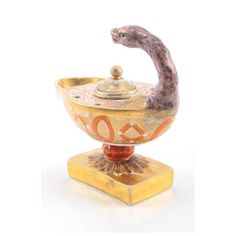 an ornately decorated bowl with a bird on it's head and the word love is