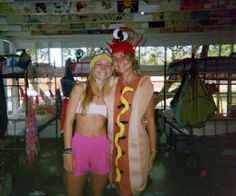 two women dressed up as hot dogs and one is wearing a costume that looks like a dog