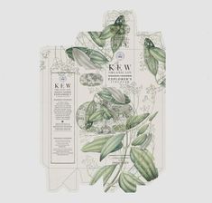 two tags with green leaves on them and the words kew written in white ink