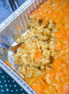 a pan filled with macaroni and cheese on top of a table