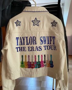 a jacket that says taylor swift the brass tour hanging on a rack in a room