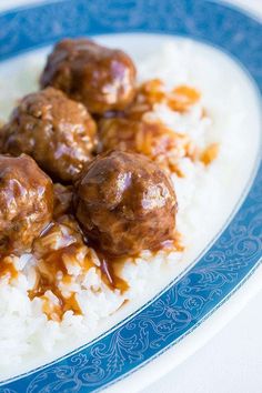 some meatballs and rice on a blue and white plate