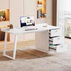 a white desk with drawers and a laptop on it