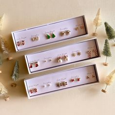 Elevate the holiday spirit with our enchanting boxed Christmas stud earring gift set, adorned with a lovely selection of 5 unique holiday studs. Crafted with meticulous attention to detail, each pair captures the whimsy and magic of the season. Whether you're dressing up for a festive gathering or simply adding a touch of Christmas cheer to your everyday look, these stud earrings are the perfect choice. Encased in a beautifully presented box, this set makes for a heartwarming and thoughtful gift Christmas Earrings Duos, Beaded Christmas Tree Earrings, Reindeer Earrings, Whimsical Accessories, Christmas Tree Earrings, Holiday Mood, Xmas Stockings, Earring Gift, Christmas Packaging