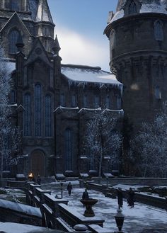 an old building with snow on the ground and people walking around it in front of it