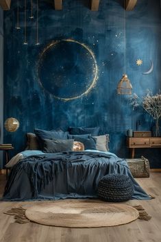 a bedroom decorated in blue and gold, with a large moon mural on the wall