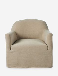 a beige chair sitting on top of a white floor