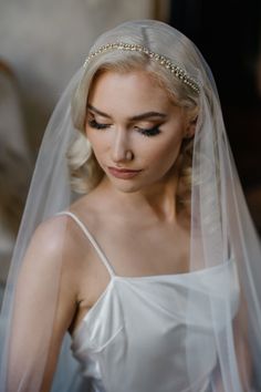 a woman wearing a wedding veil and tiara