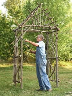 an old man is building a wooden arbor in the yard with text that reads, create your own arbor trellis using materials just lying around