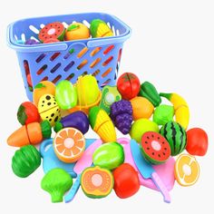 a blue basket filled with lots of different types of fruits and vegetables on top of a white surface