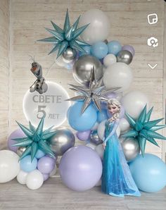 the frozen princess is standing in front of balloons