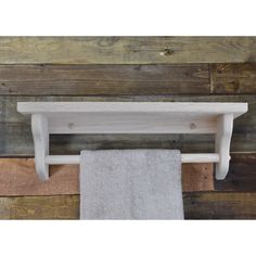 a white towel rack on a wooden wall