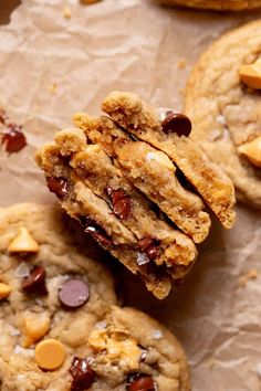 chocolate chip cookies are stacked on top of each other with one cookie broken in half