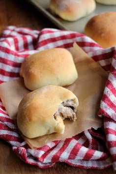 two rolls are sitting on a red and white towel