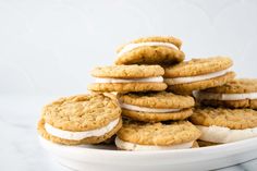 a white plate topped with cookies and marshmallows on top of each other