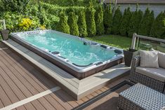 a hot tub sitting on top of a wooden deck