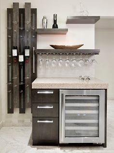 there is a wine rack in the middle of this kitchen