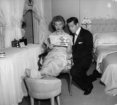 an old black and white photo of two people in a bedroom