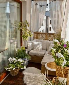 an outdoor living area with wicker furniture and potted plants on the roof terrace