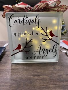 a glass box with the words cardinals appear when angels are near on top of a table