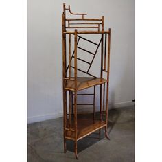 a tall wooden shelf sitting on top of a cement floor