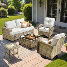 an outdoor patio with wicker furniture and pillows