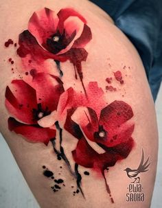 a woman's thigh with red flowers painted on it and watercolor splashs