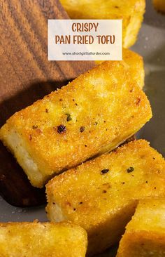 crispy pan fried tofu on a cutting board with text overlay that reads crispy pan fried tofu