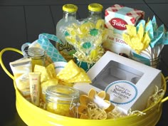 a yellow bucket filled with lots of different items