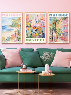 a living room filled with green couches and paintings on the wall above them that say matissee