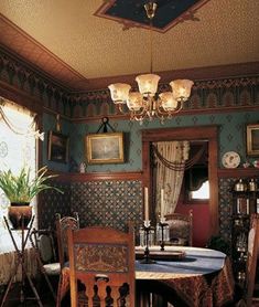 a dining room table and chairs in front of a mirror with pictures on the wall