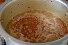 a pot filled with liquid sitting on top of a stove